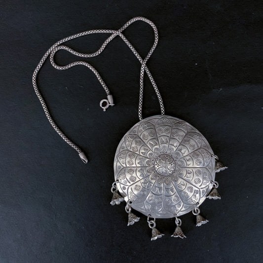 silver round pendant with unique etching